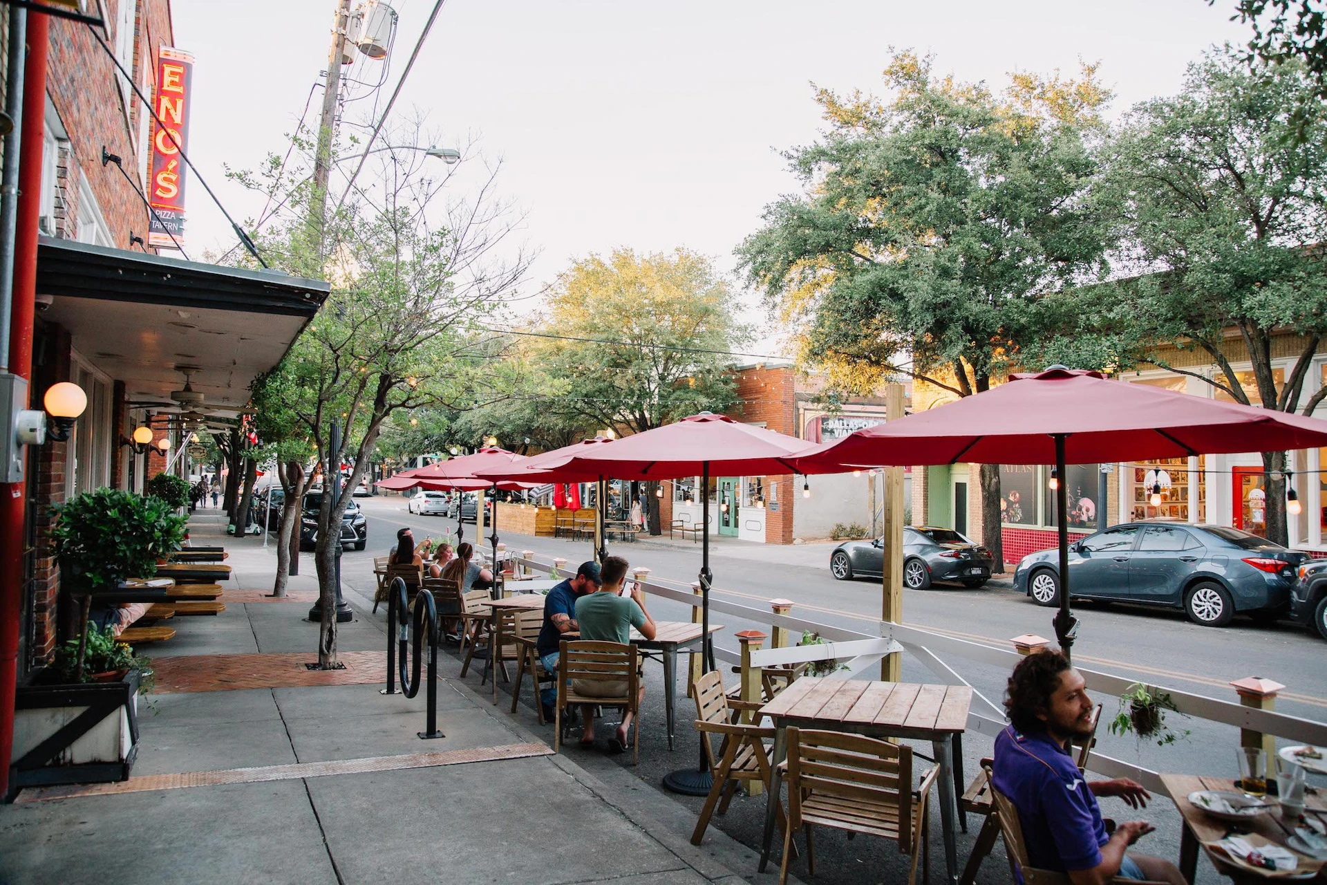 Real Dallas neighborhood scene near Bishop Arts District with outdoor dining and local character